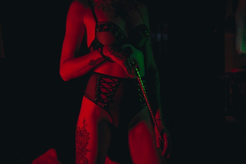 woman in red lingerie singing bdsm